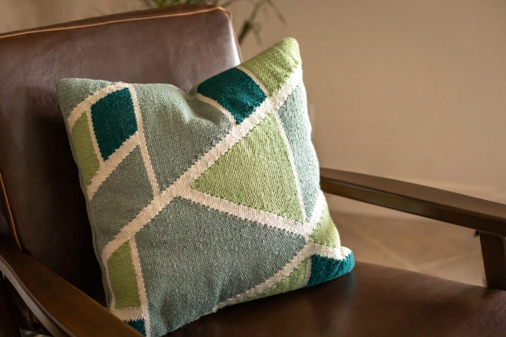 Bring a Touch of Nature Indoors with These Refreshing Green Geometric-Patterned Pillows That Transforms an Ordinary Brown Couch & Chair Into Extraordinary