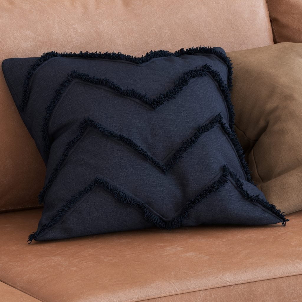 Deep Blue Pillow with Texture Trim Showcases an Amber Toned Couch in a Modern Design