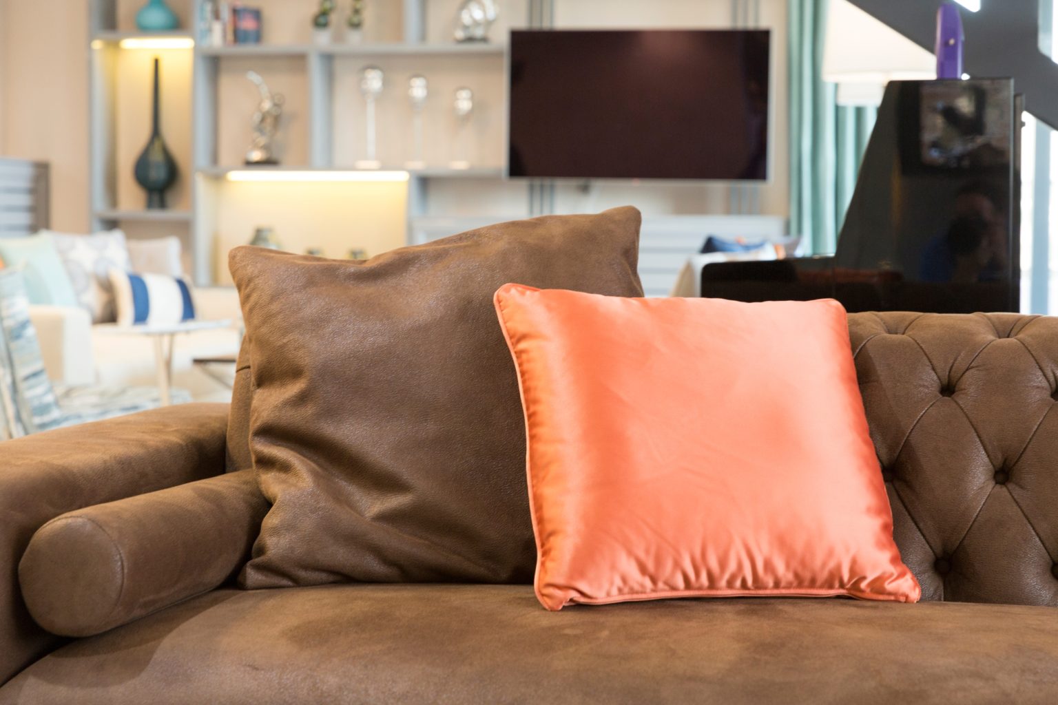 pillow arrangements on leather sofa