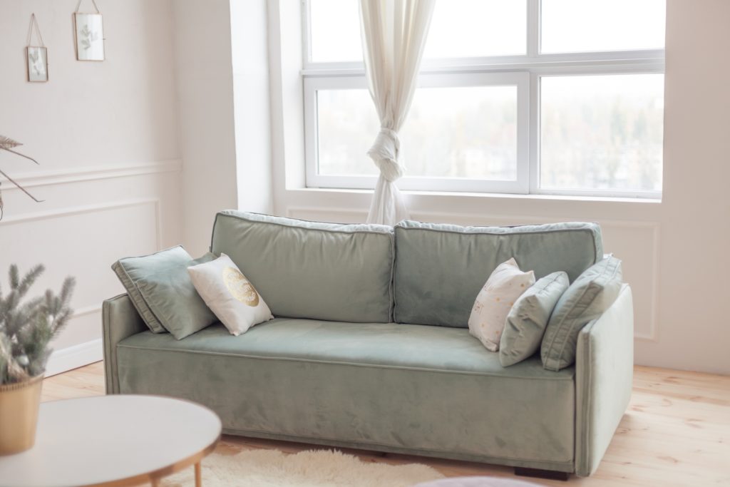Large Velvet Pale-Pistachio-Green Sofa Boasting a Classic Design Appears Regal & Luxurious with Mix of Accent Pillows