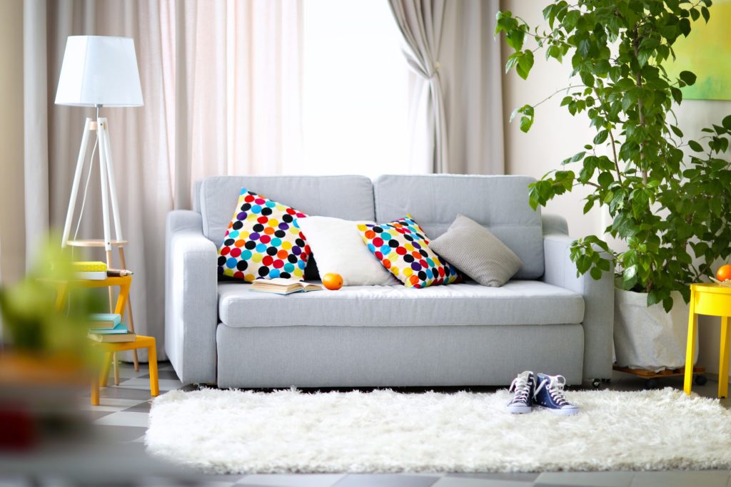 Light Gray Couch with Multi Colored Throw Pillow Accents