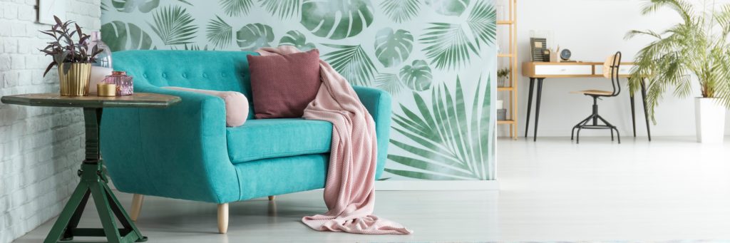 Modern Turquois Green Couch Accented with Mauve Pink Blanket Pillow