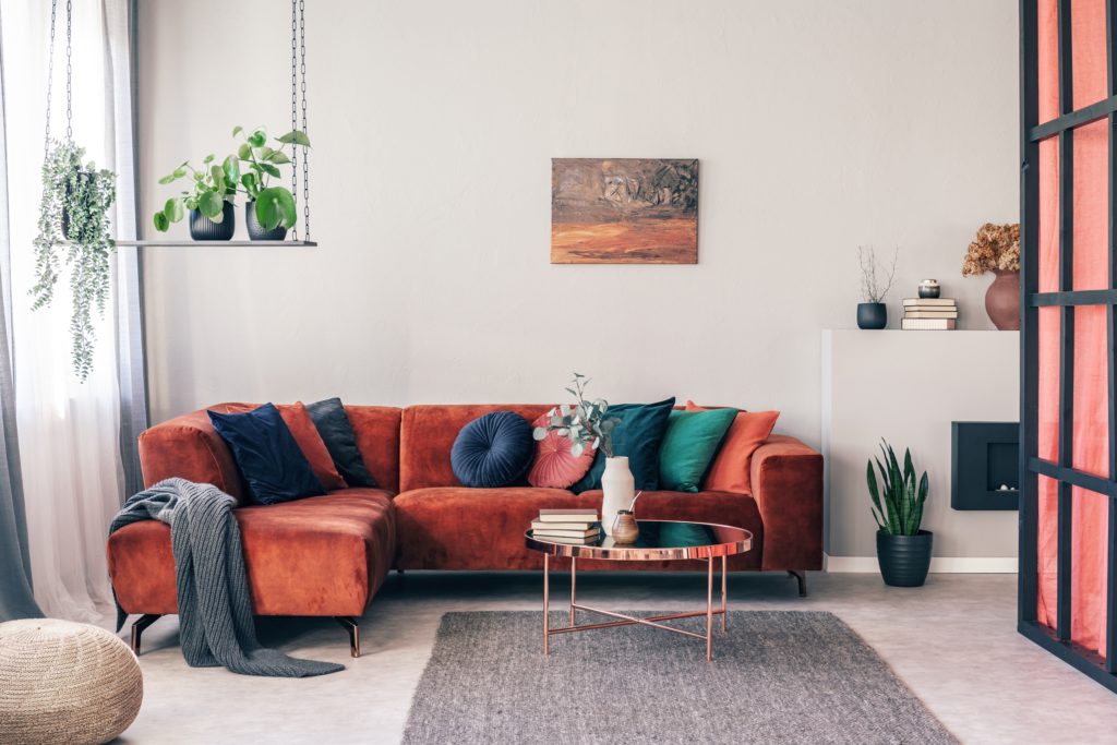 Stylish Red Corner Couch with Colorful Pillows in a Modern Interior