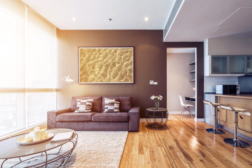 Living Room with Stylish Brown Couch Beige Patterned Rug and Window Wall