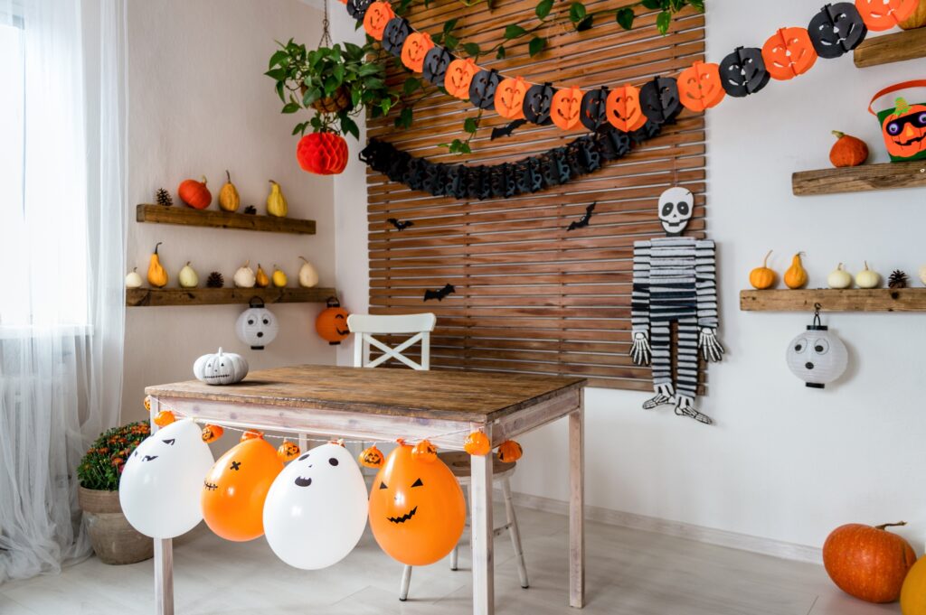 Halloween Living Room Display with Pumpkins, Gourds, Balloons and Skeleton