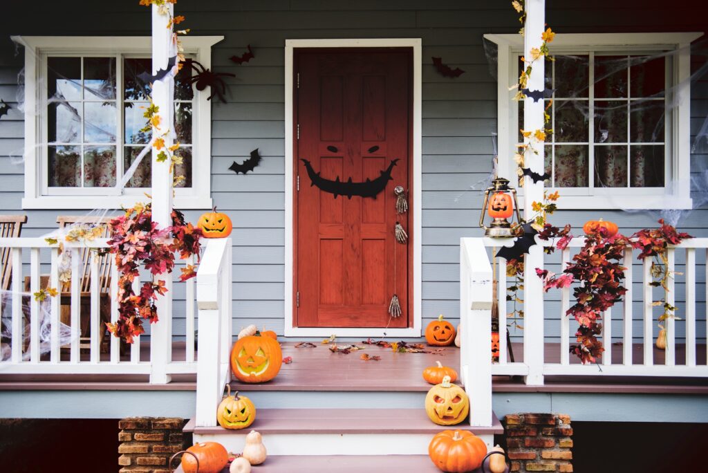 Porch with Funny and Fierce Halloween Jack o’ Lanterns and Autumn Leaves
