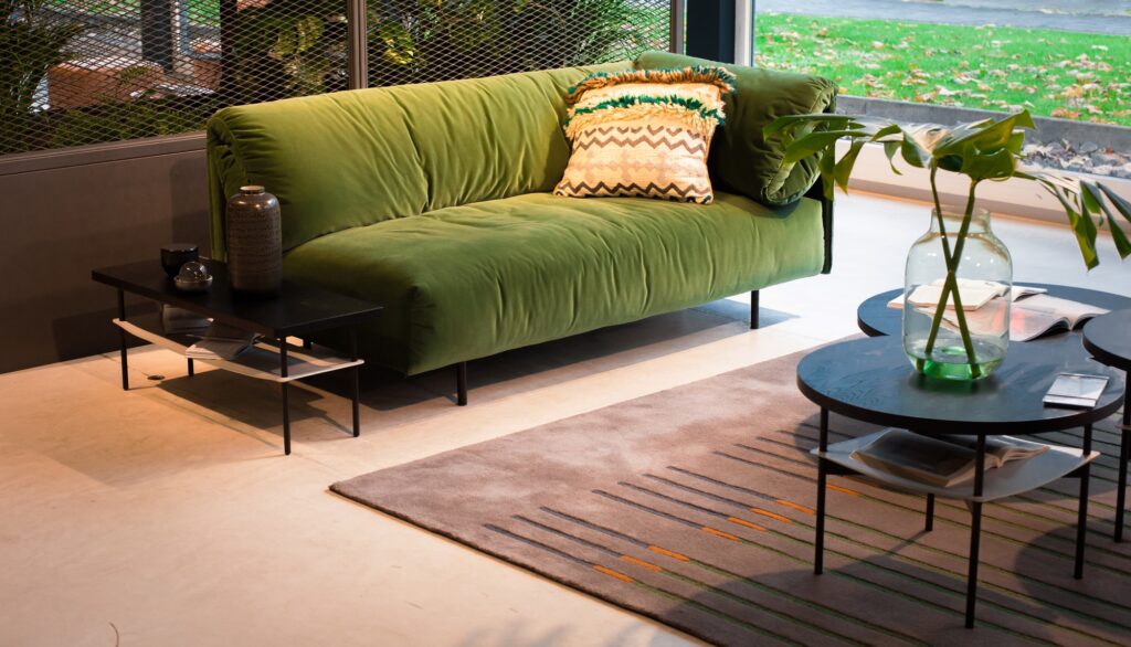 Vintage Green Velvet Couch in Solarium Corner with Rustic Brown Rug